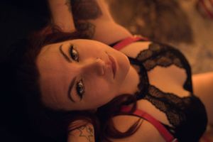 Intimate portrait in warm lighting with black lace accents.