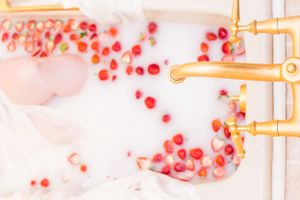 Abstract pink and red scattered dots with gold accents create a dreamy artistic composition.