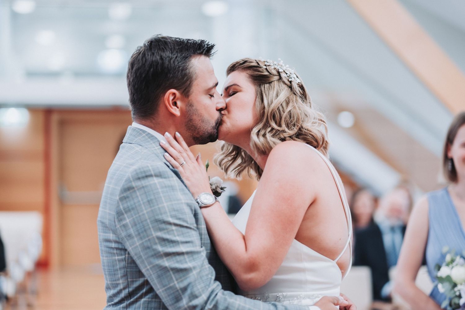 Romantic kiss between newlyweds during wedding ceremony.