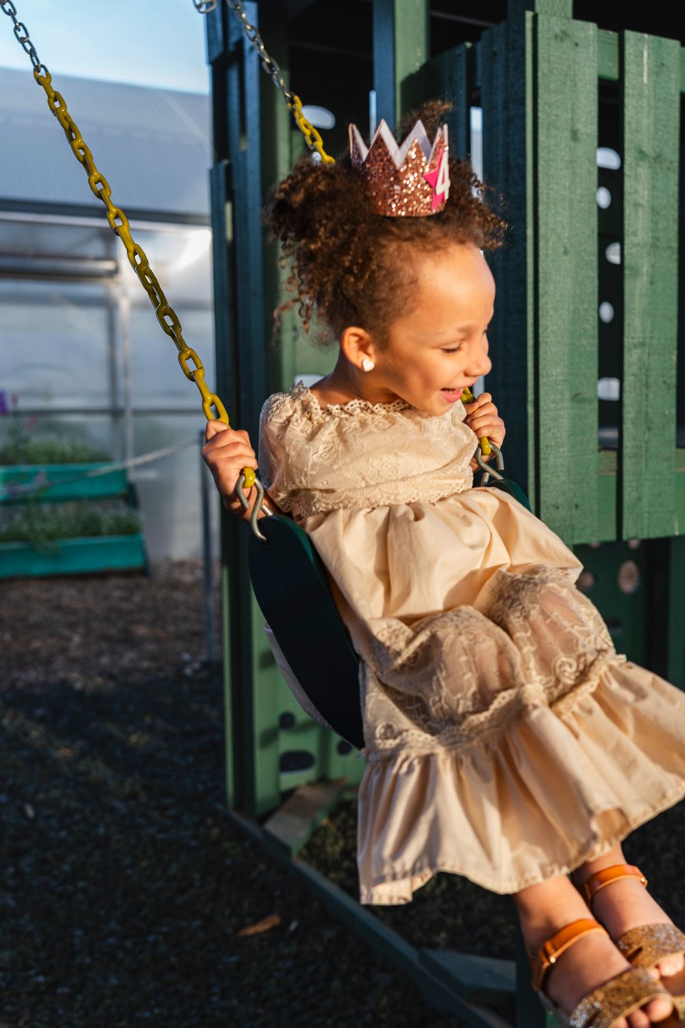 A candid playground swing photo showing pure joy and laughter.