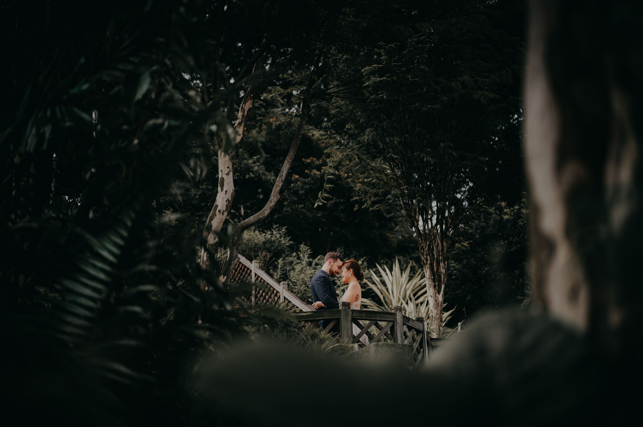 Intimate couple portrait in Fort Canning with forest theme background