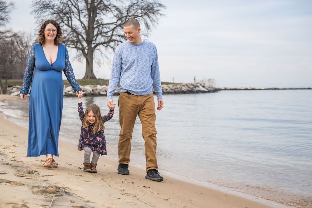 Family walking on the beach photo at Sandy Point State Park. Kent Island maternity photographer. Annapolis maternity photographer