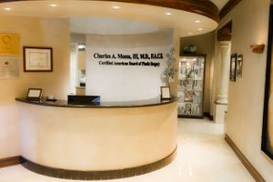 Curved reception desk in medical office with warm lighting and professional signage.