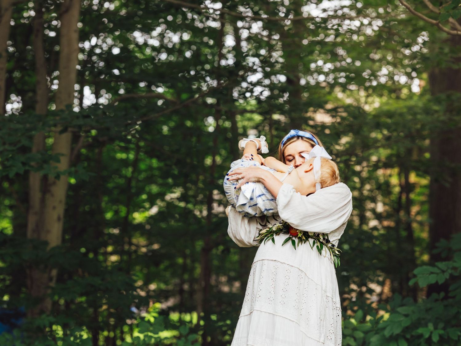 maternity photo of mama to be playing with toddler at backyard baby shower