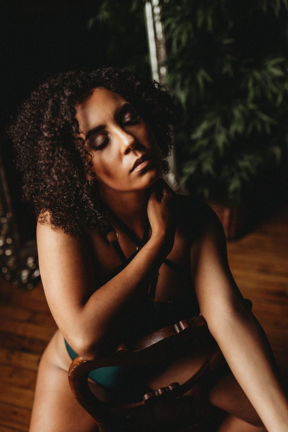 Sensual portrait with dramatic lighting and rich skin tones.