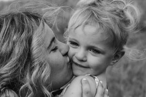 A tender black and white moment of affection between parent and child.