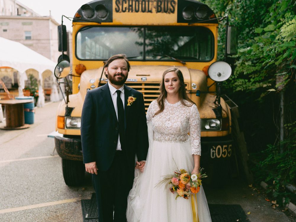 Yellow school bus decorated for wedding transportation with 'just married' signage.