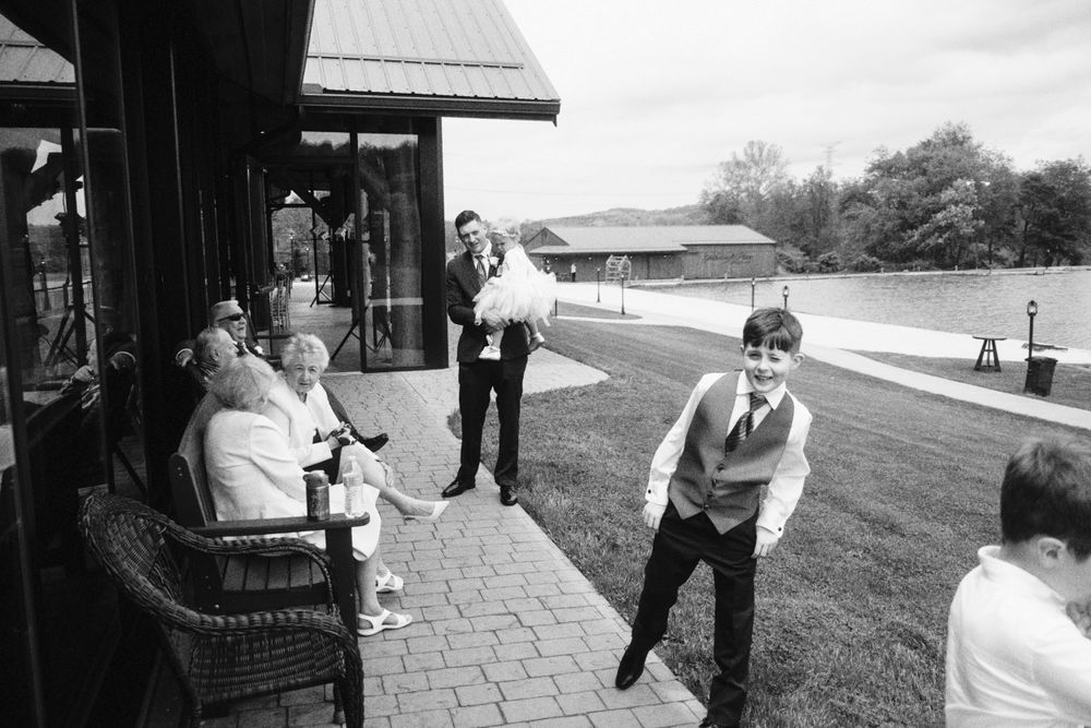 Guests relaxing on a porch during an outdoor event.