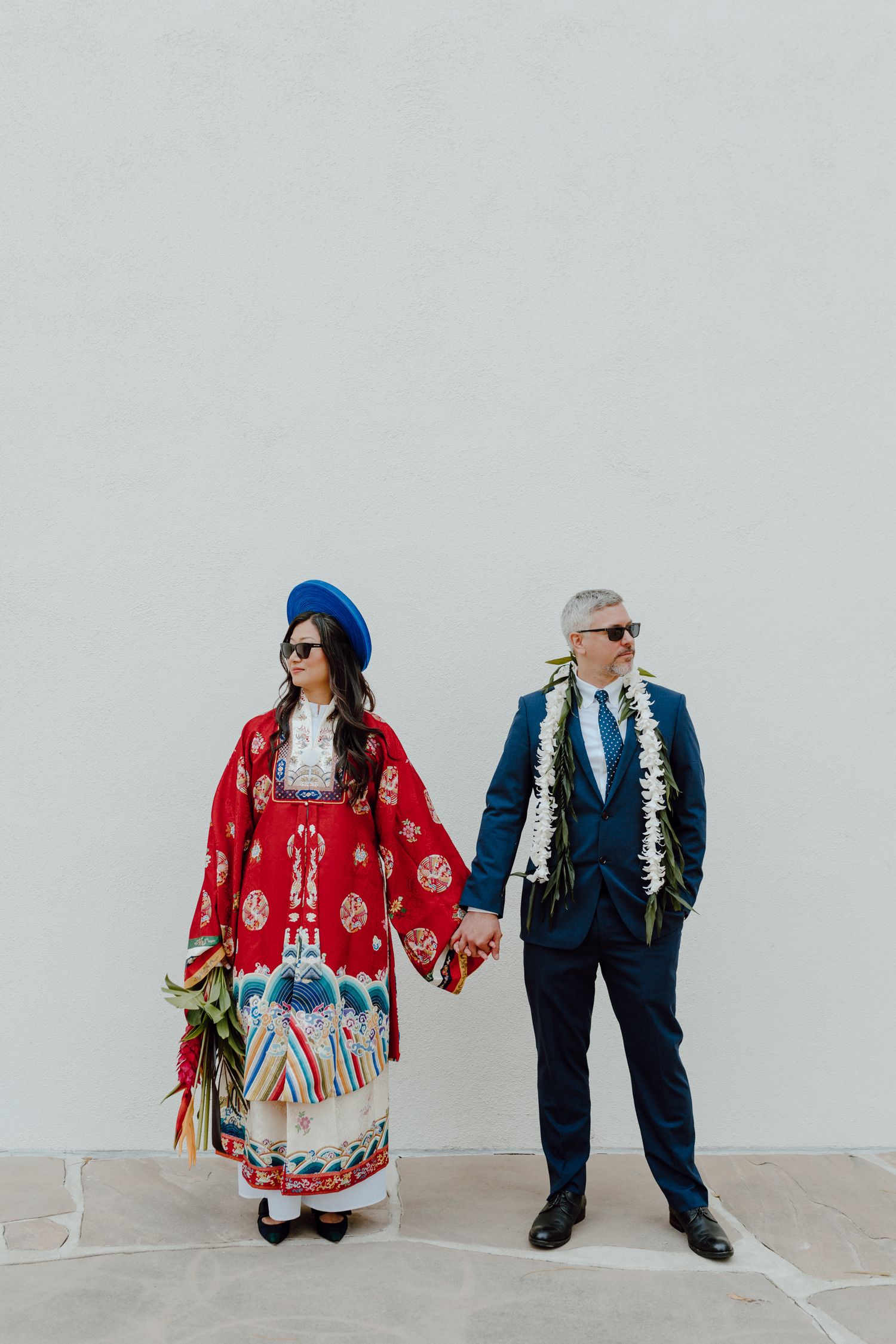 A married couple does an editorial pose together on their wedding day while in traditional Vietnamese Wedding clothing.