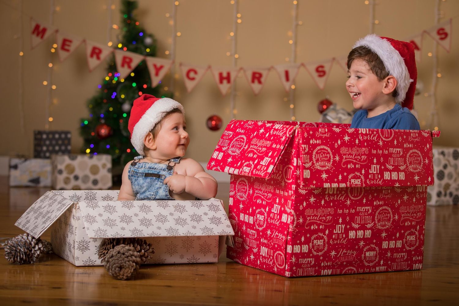 Christmas photo of brothers in present boxes