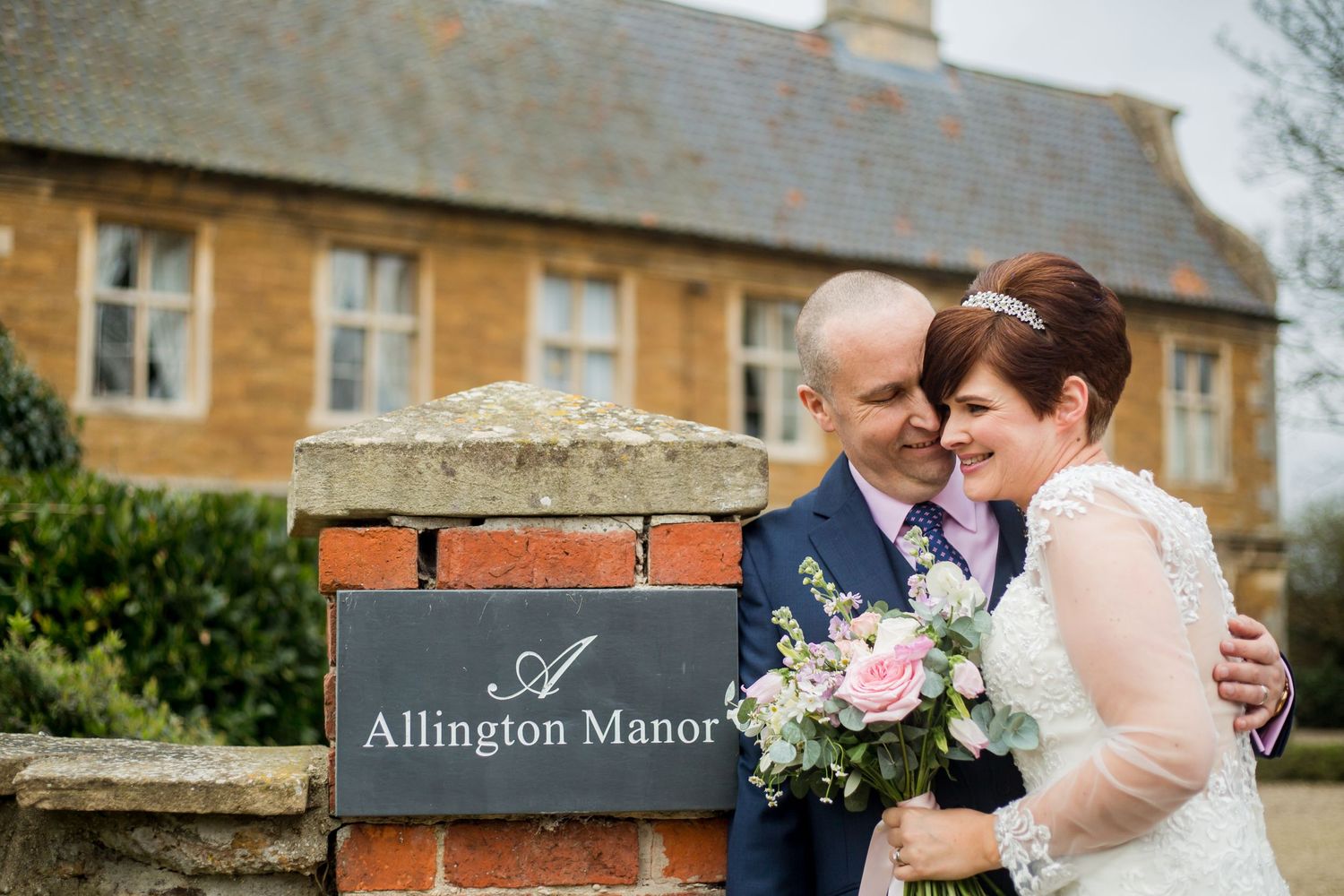 Historic stone manor house with classic architecture and manicured grounds at Allington Manor.