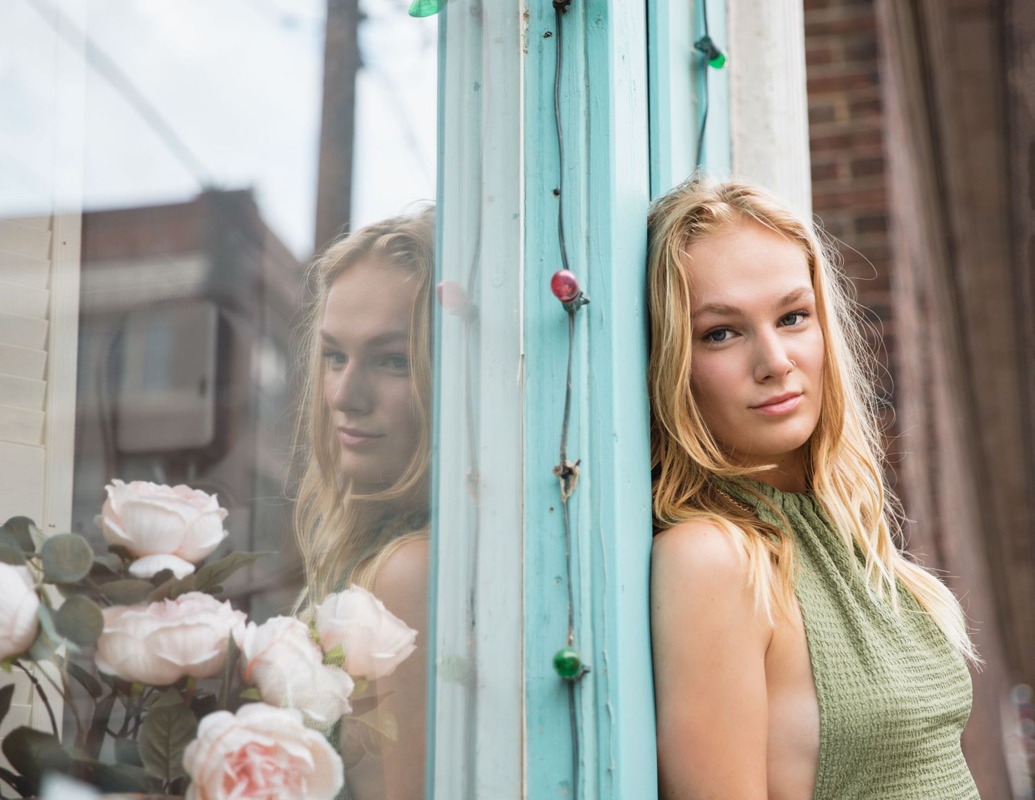 senior photoshoot in west bottoms with teal blue background