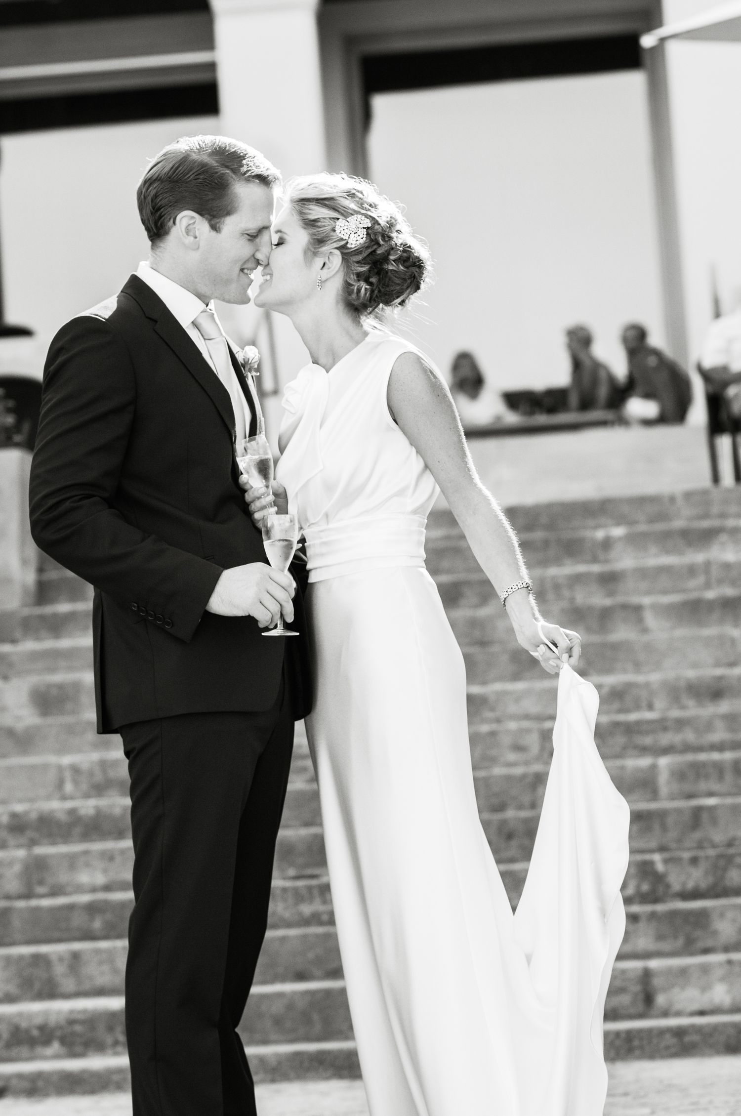 The bride and groom on their wedding day on the steps of the Hotel Miramar in Montjuic, Barcelona.