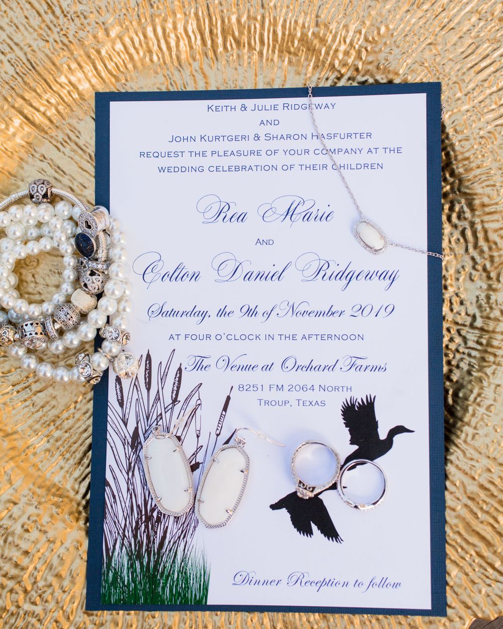 Navy and white wedding invitation featuring duck silhouettes and cattails design.