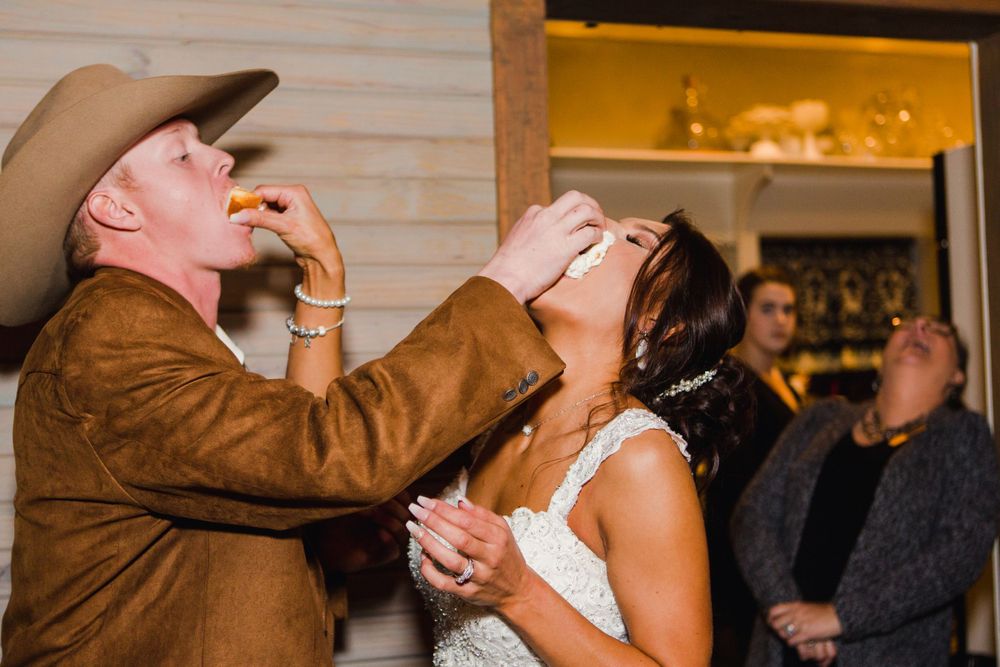 A playful moment during the wedding reception as couple takes shots together.