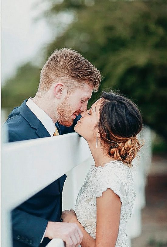 Romantic wedding couple sharing an intimate moment during their outdoor portrait session.