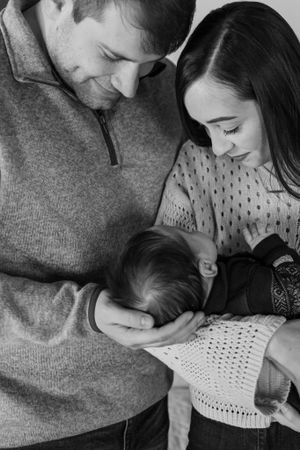 Intimate black and white portrait of a family sharing a tender moment together.