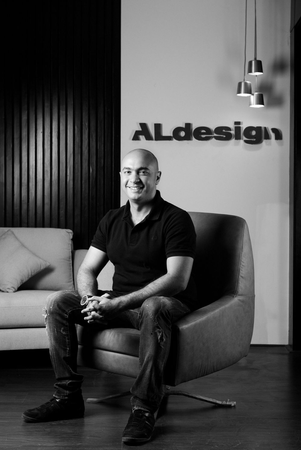 Modern office portrait with ALdesign branding and contemporary furniture in black and white.