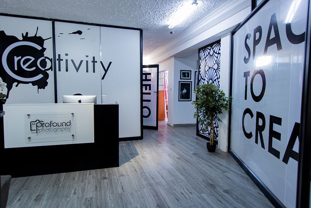 Creative office space with minimalist decor and Space to Create wall text.