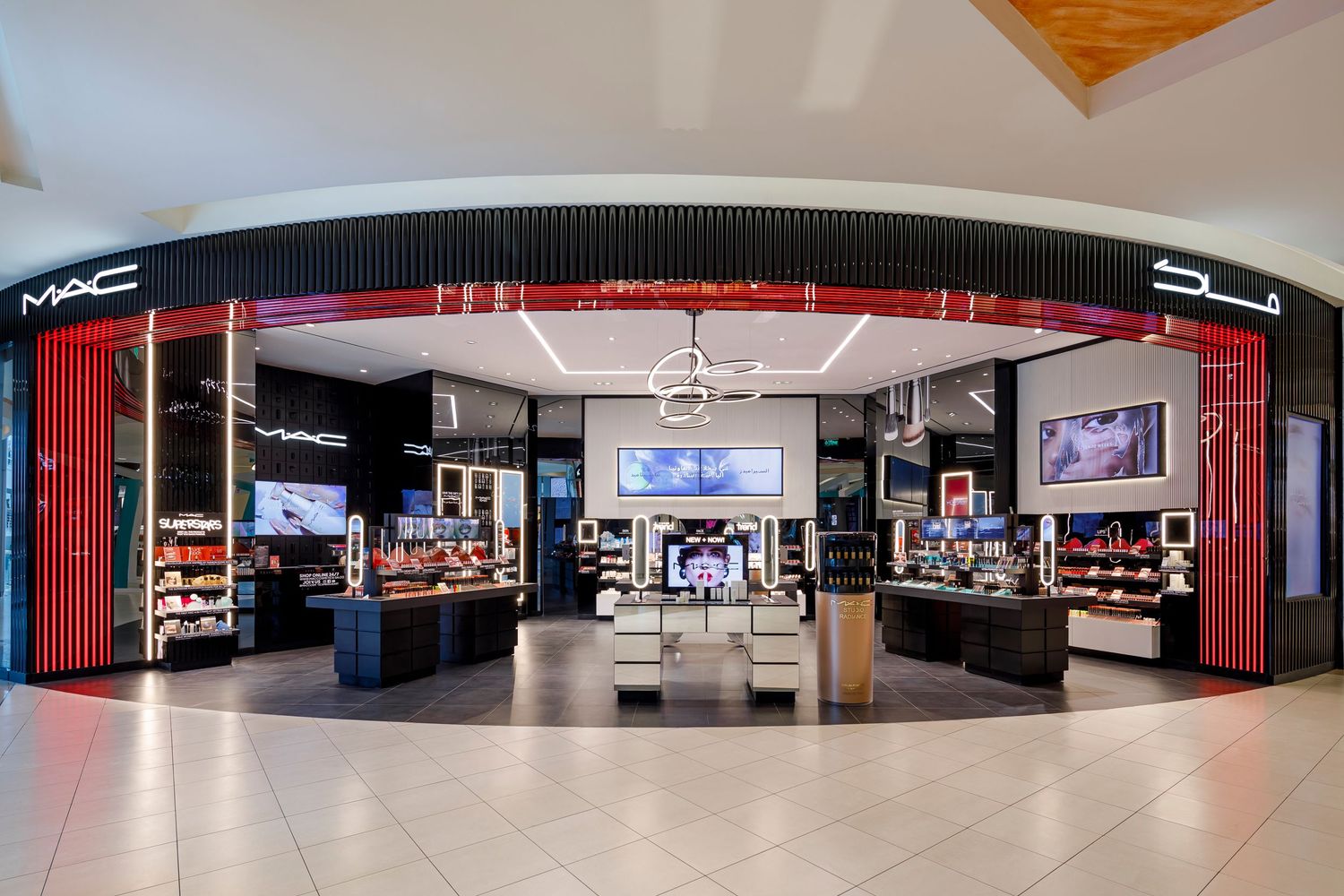 Modern MAC cosmetics storefront with sleek red and black design in shopping mall.