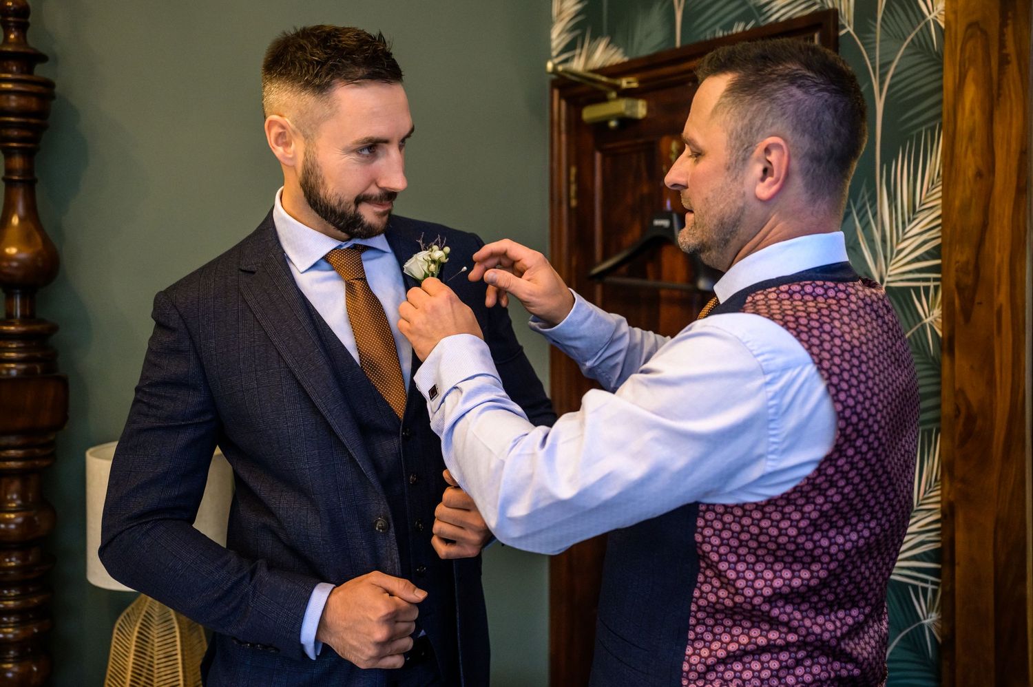 Best man fixing groom's button hole at Broadoaks Country House