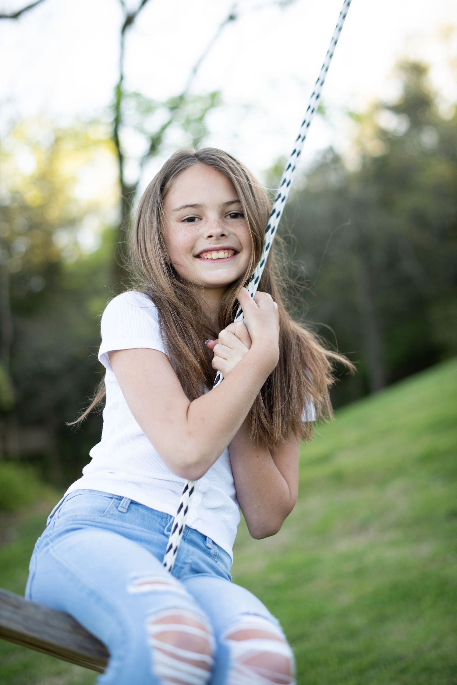 Someone enjoying a swing ride outdoors on a sunny afternoon.