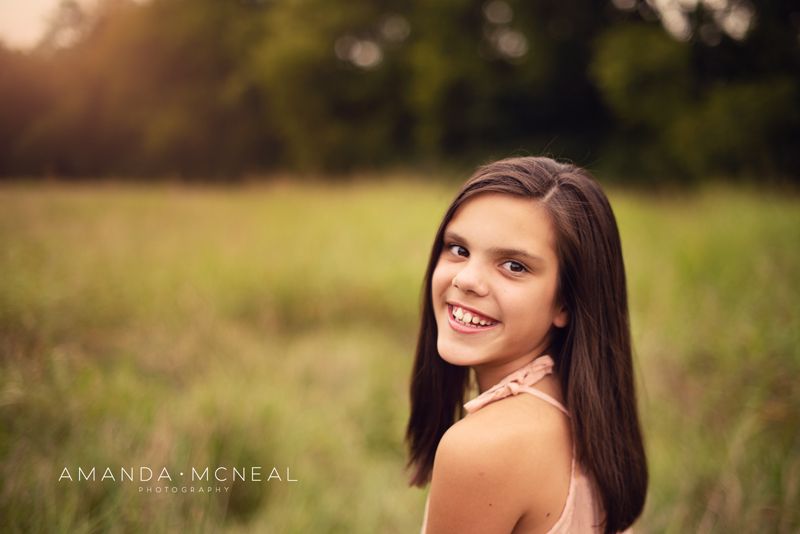 Vibrant sunset portrait session with golden hour lighting in a natural outdoor setting.