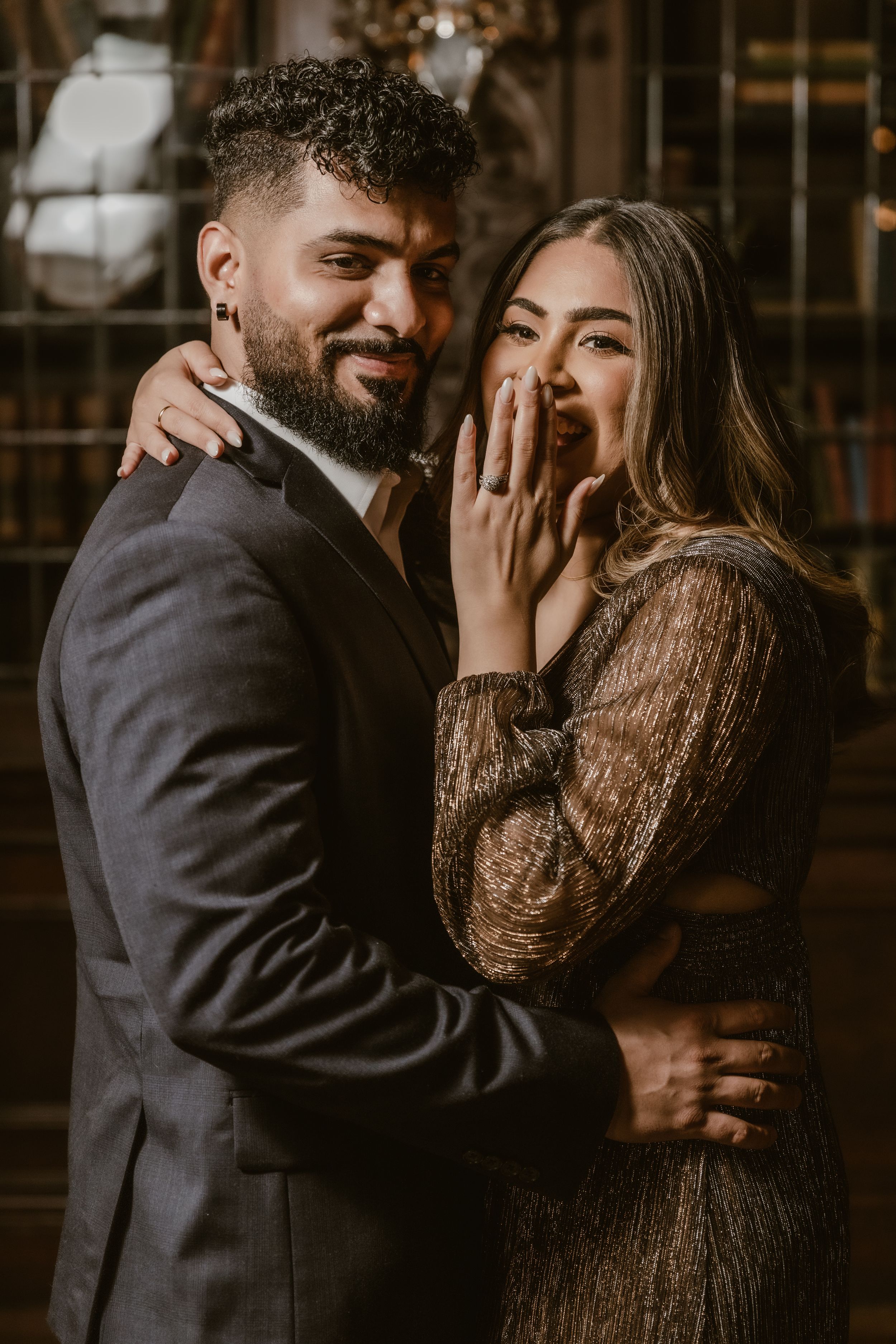 Intimate engagement photos in warm lighting with couple in formal attire.