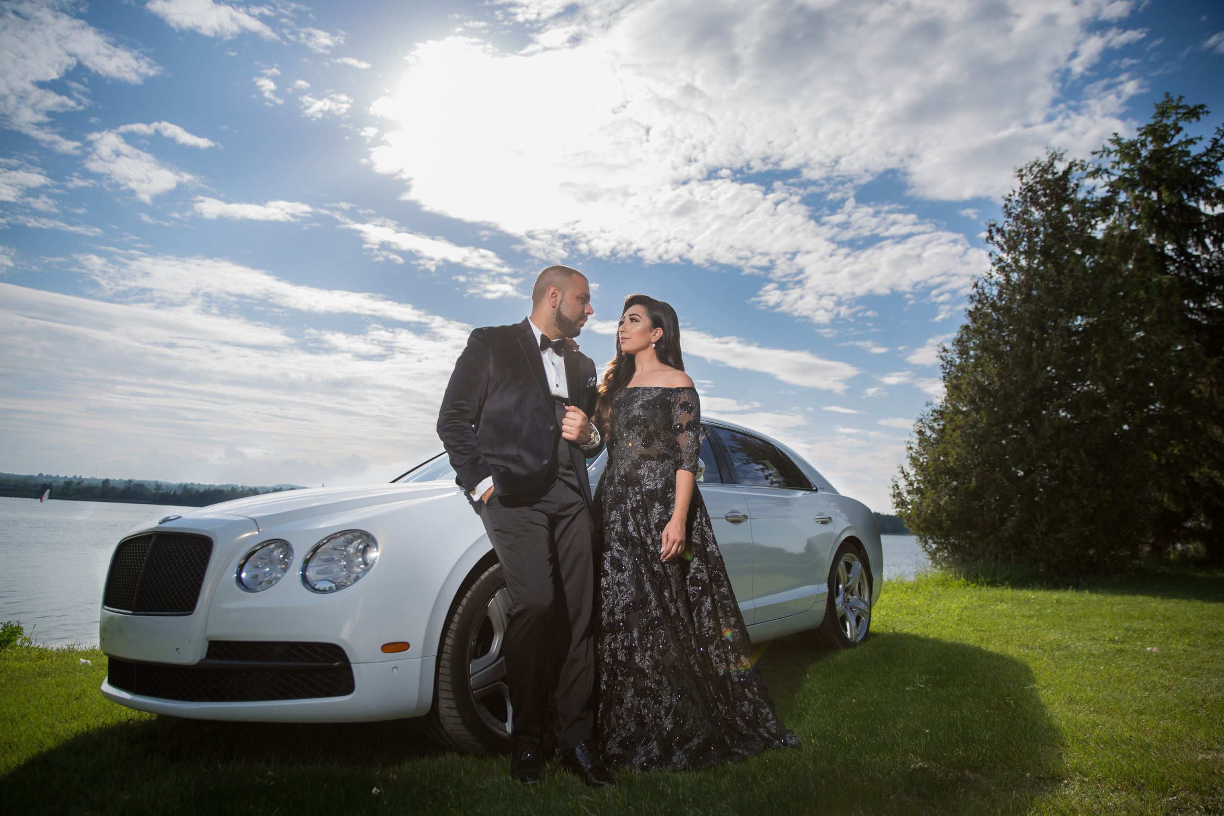 Elegant photo session with luxury white sports car in scenic outdoor setting.