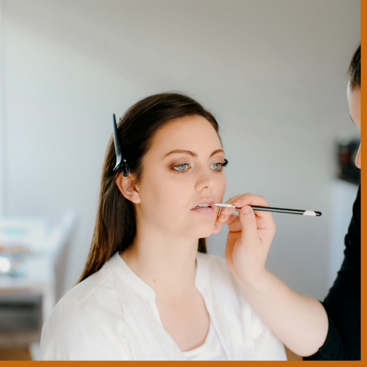 woman getting make up done make up artist