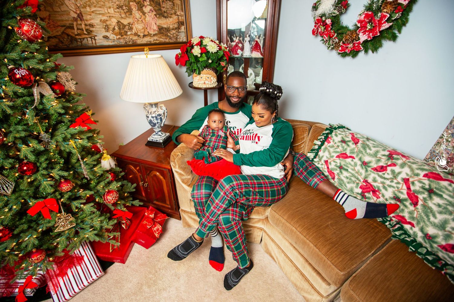 Family enjoying Christmas together surrounded by decorations and presents.