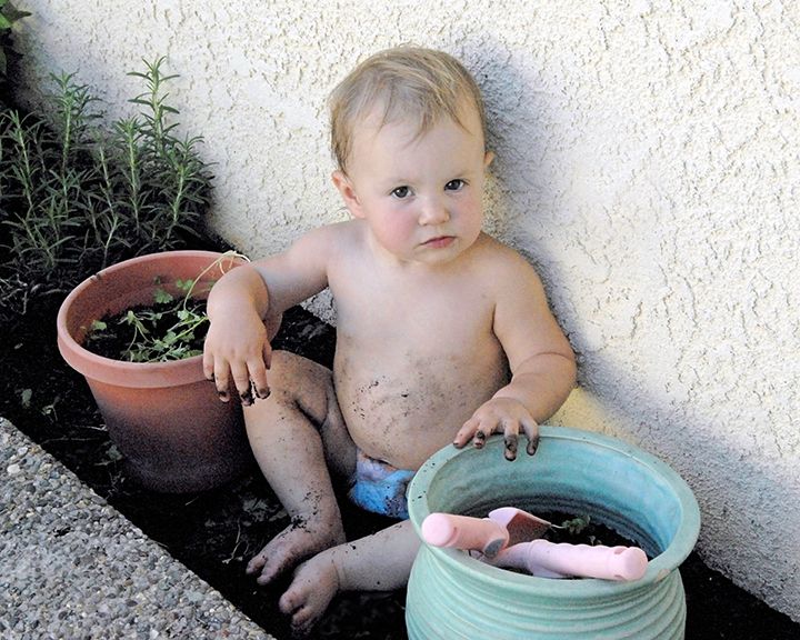 Peyton Sa  baby muddy in the flowerbed