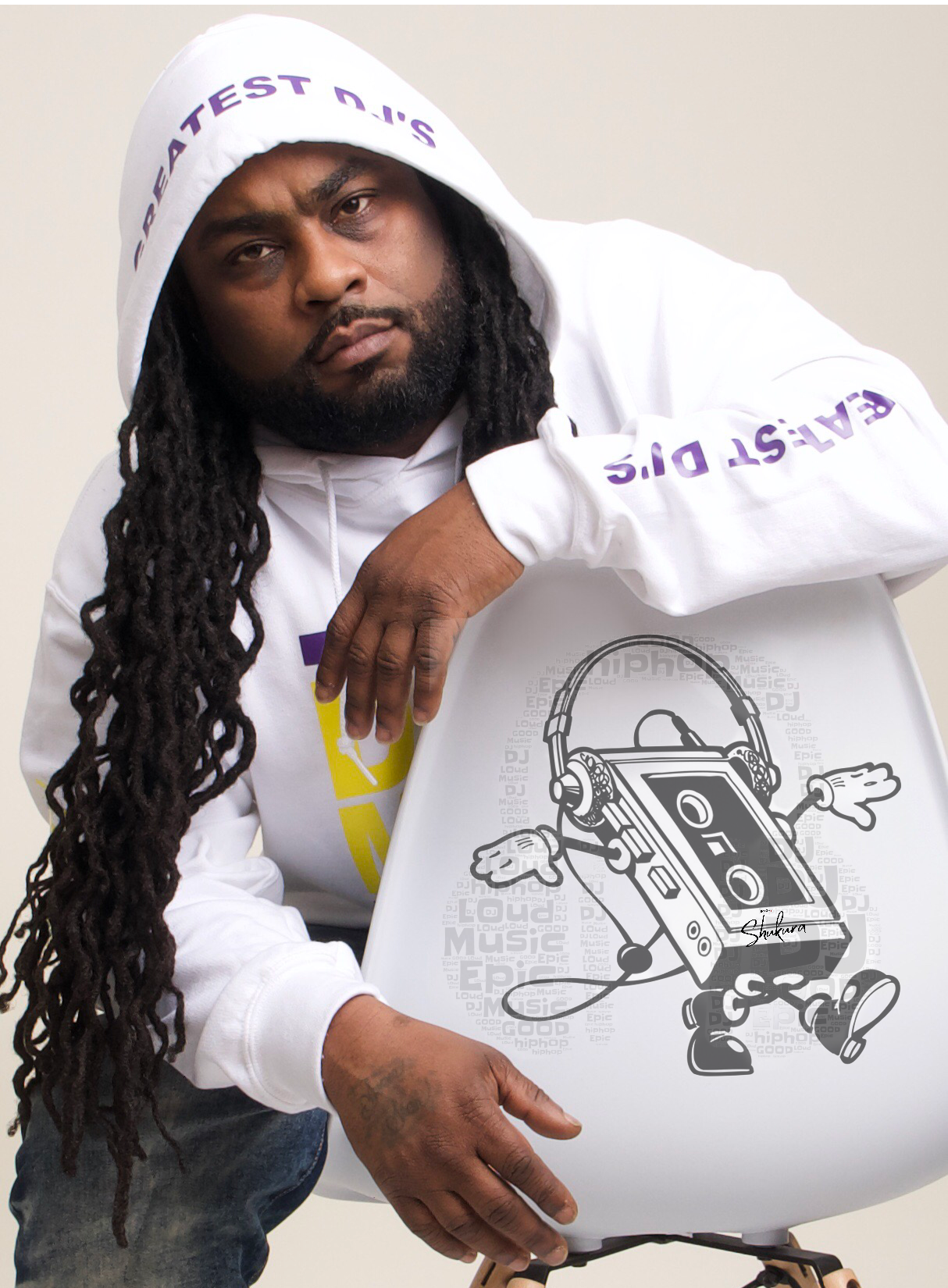 Musician in white hoodie holding graphic art design featuring cassette character.