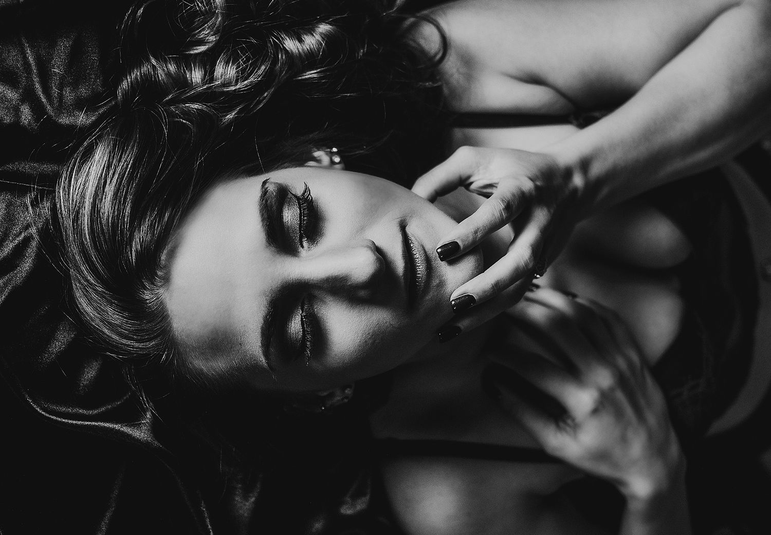 A moody black and white photo series captures artistic poses in dramatic low-key lighting.