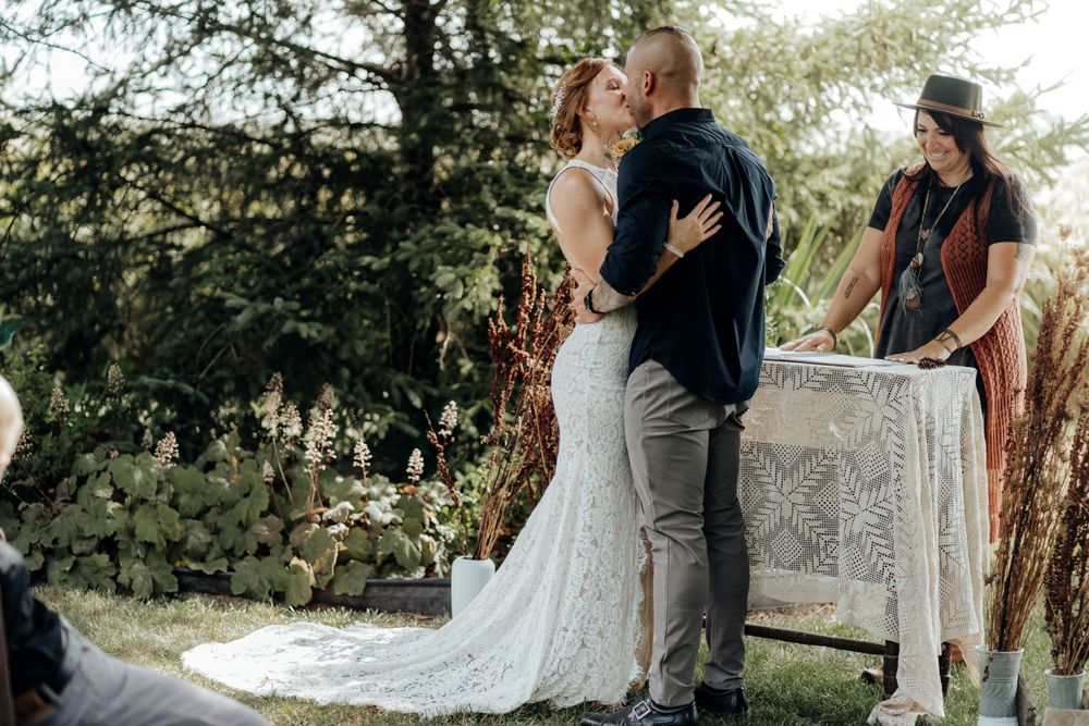 Bride and groom sharing their first kiss.