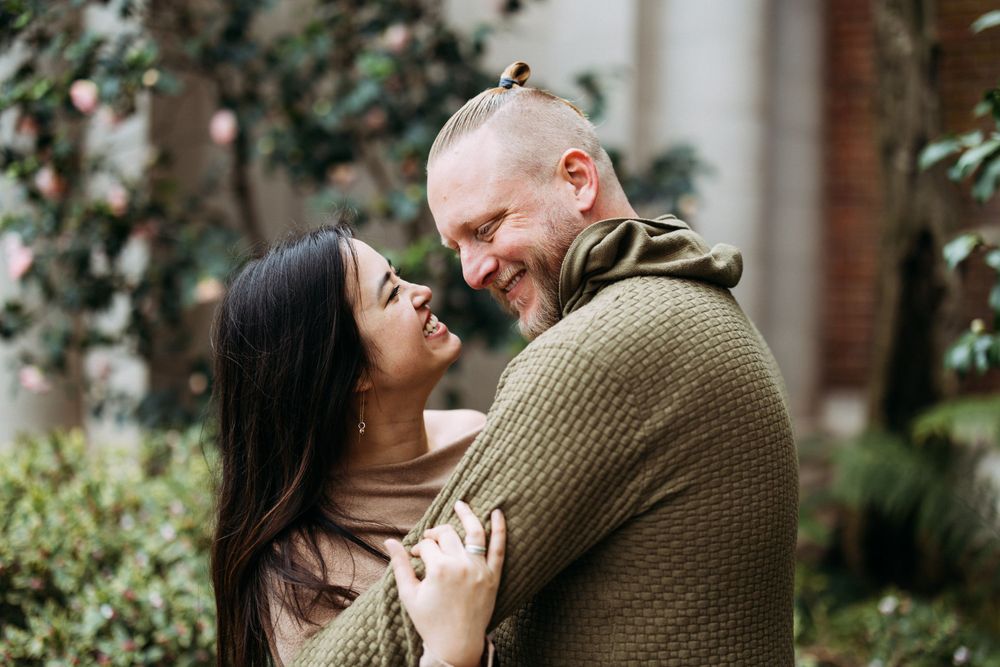 Romantic engagement photos with blooming flowers in winter in South Bay, California.