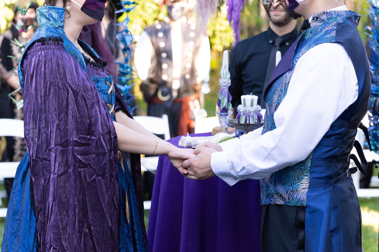 Bride and groom holding hands during their wedding ceremony.