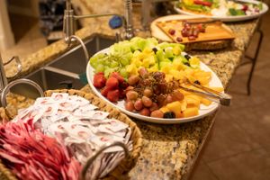 Elegant buffet spread with various appetizers and dishes on a granite countertop.