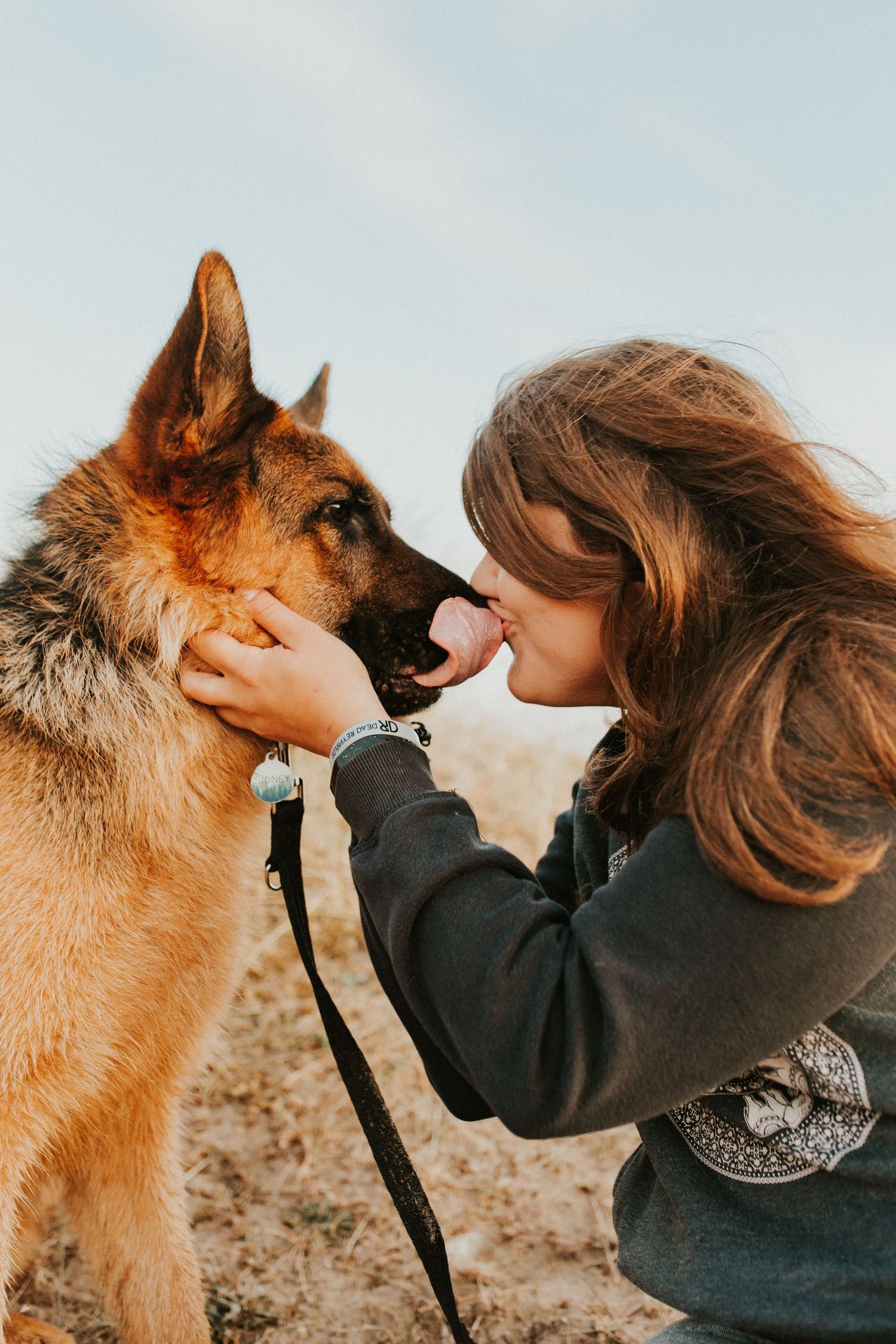me with German shepherd kissing at the beach