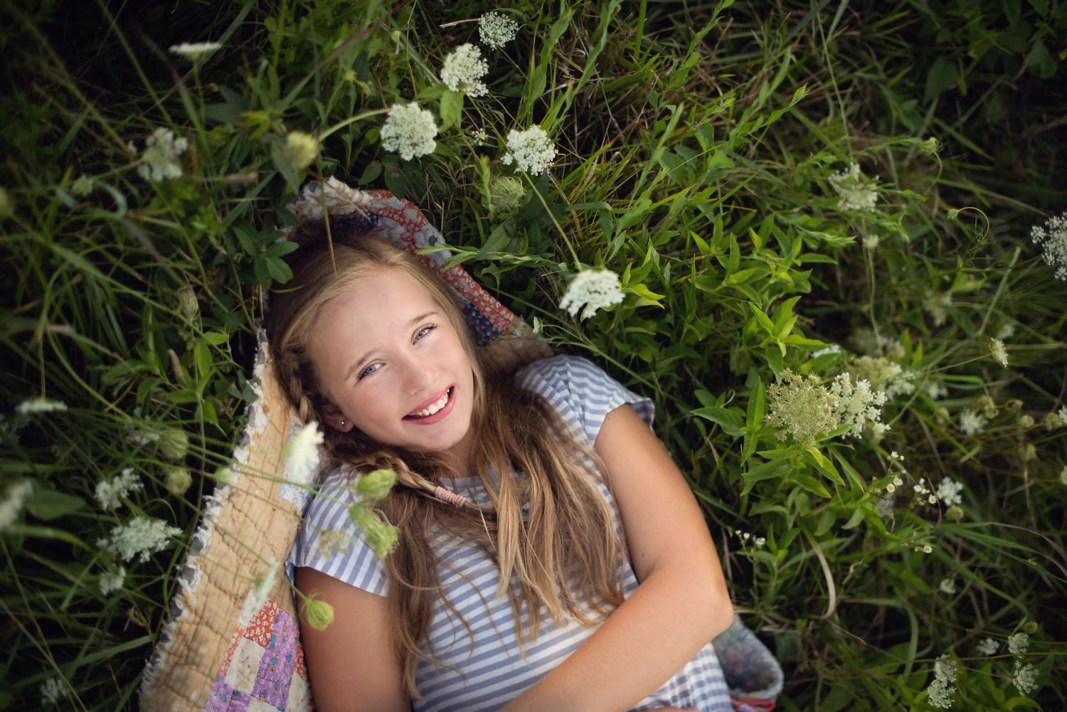 Summer portrait session in a garden with white wildflowers.