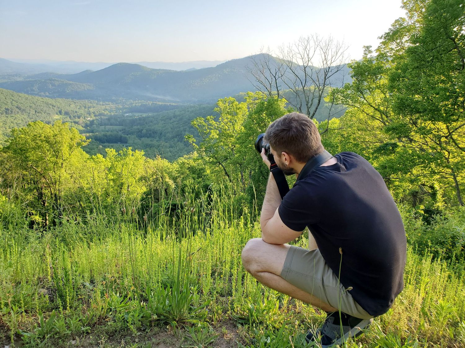 Photo of Blue Ridge Parkway overlook with photographer Virtually Calhoun taking a photo of mountains