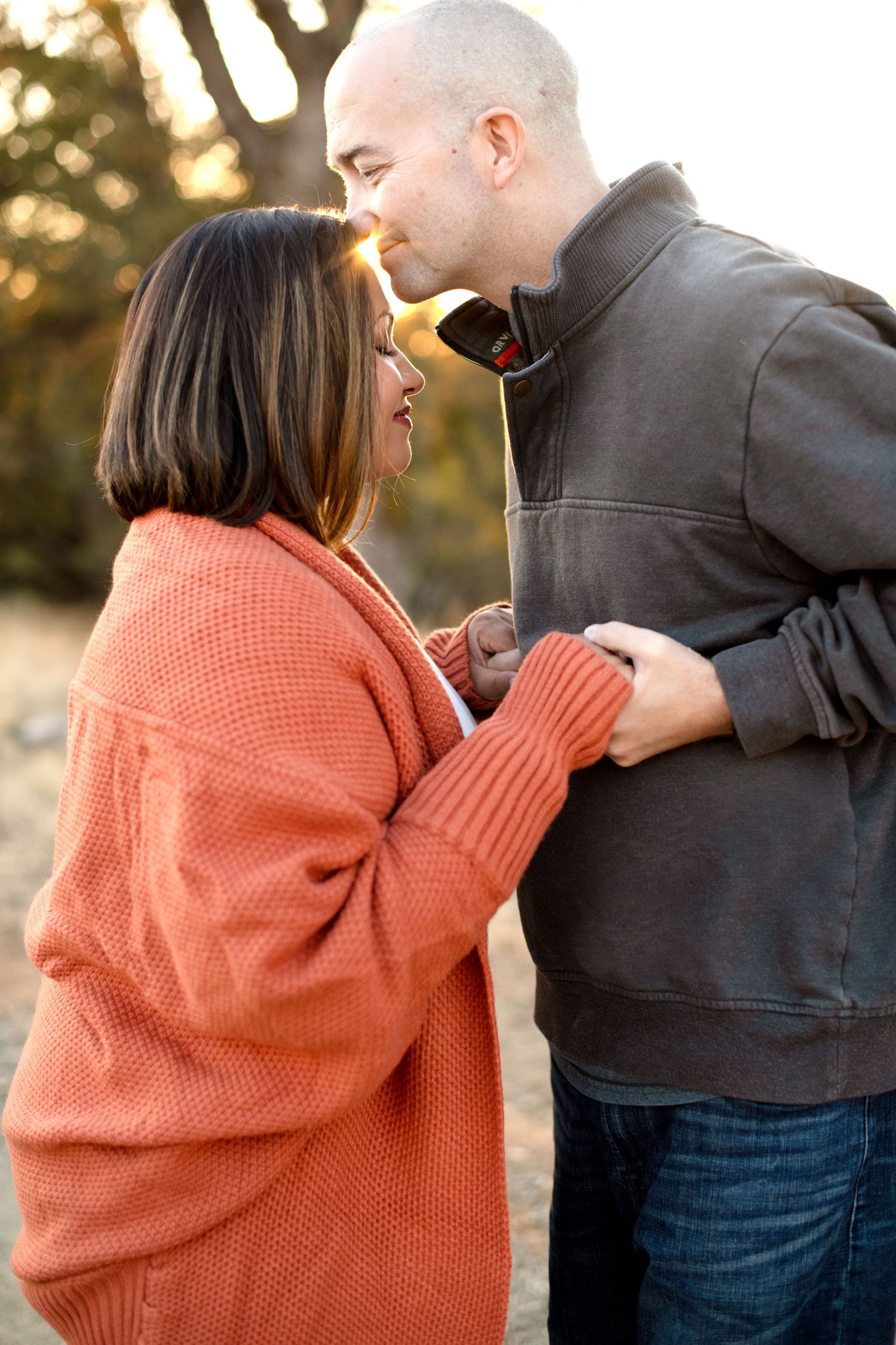 Progressive shots of a tender moment between two people dressed in fall colors outdoors.