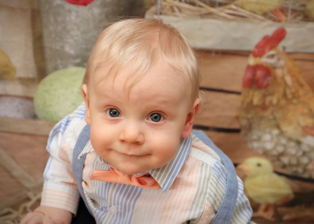 Vintage-style portrait showing bright blue eyes and striped outfit.