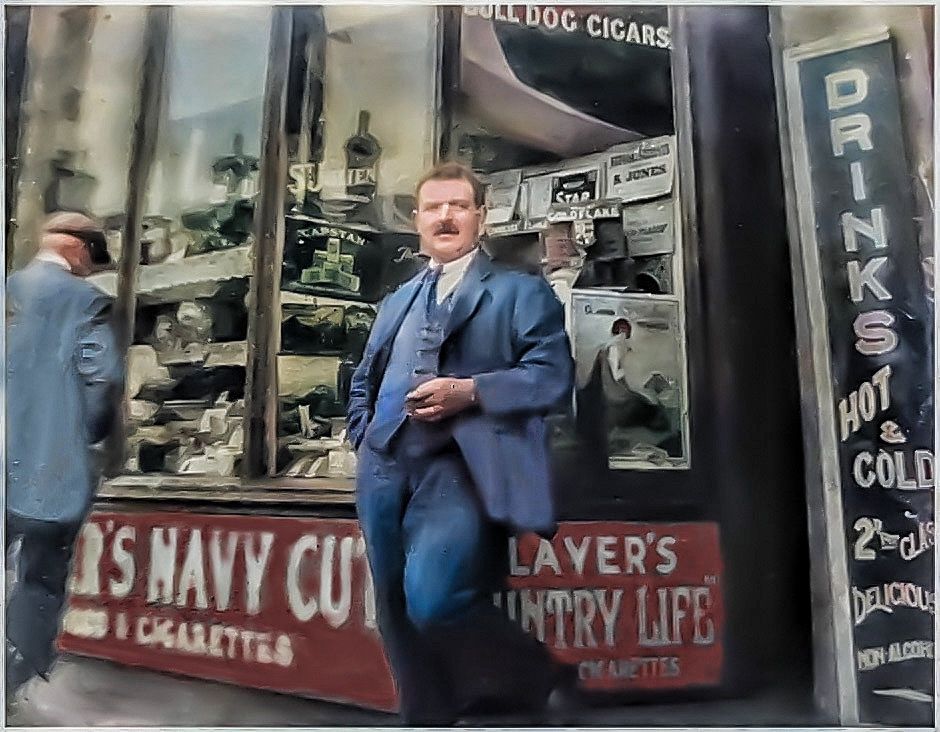 Enhanced vintage photo shows storefront with tobacco advertisements and signage for drinks.