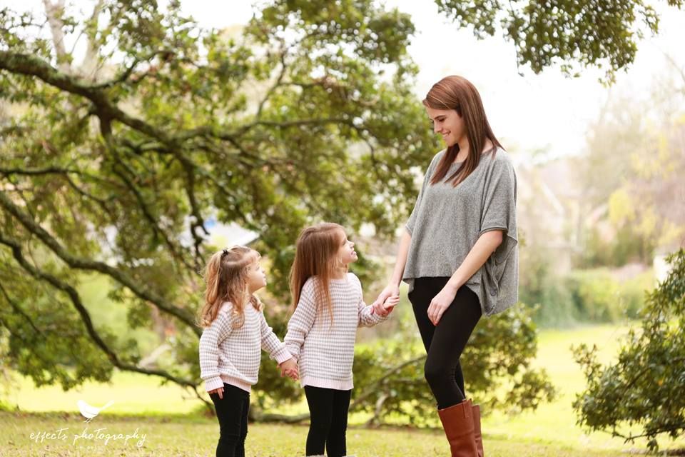 Family enjoying outdoor time together in a sunlit park setting.