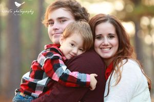 Candid family moment captured during outdoor photo session.