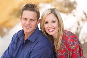 Portrait of couple in casual attire against warm autumn background.