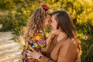 An intimate moment shared between two people in autumn sunlight on a nature path.