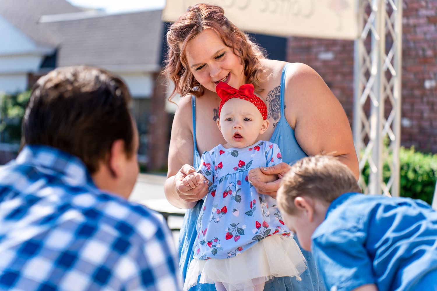 baby girl playing with family outside of SoulWise Coffee