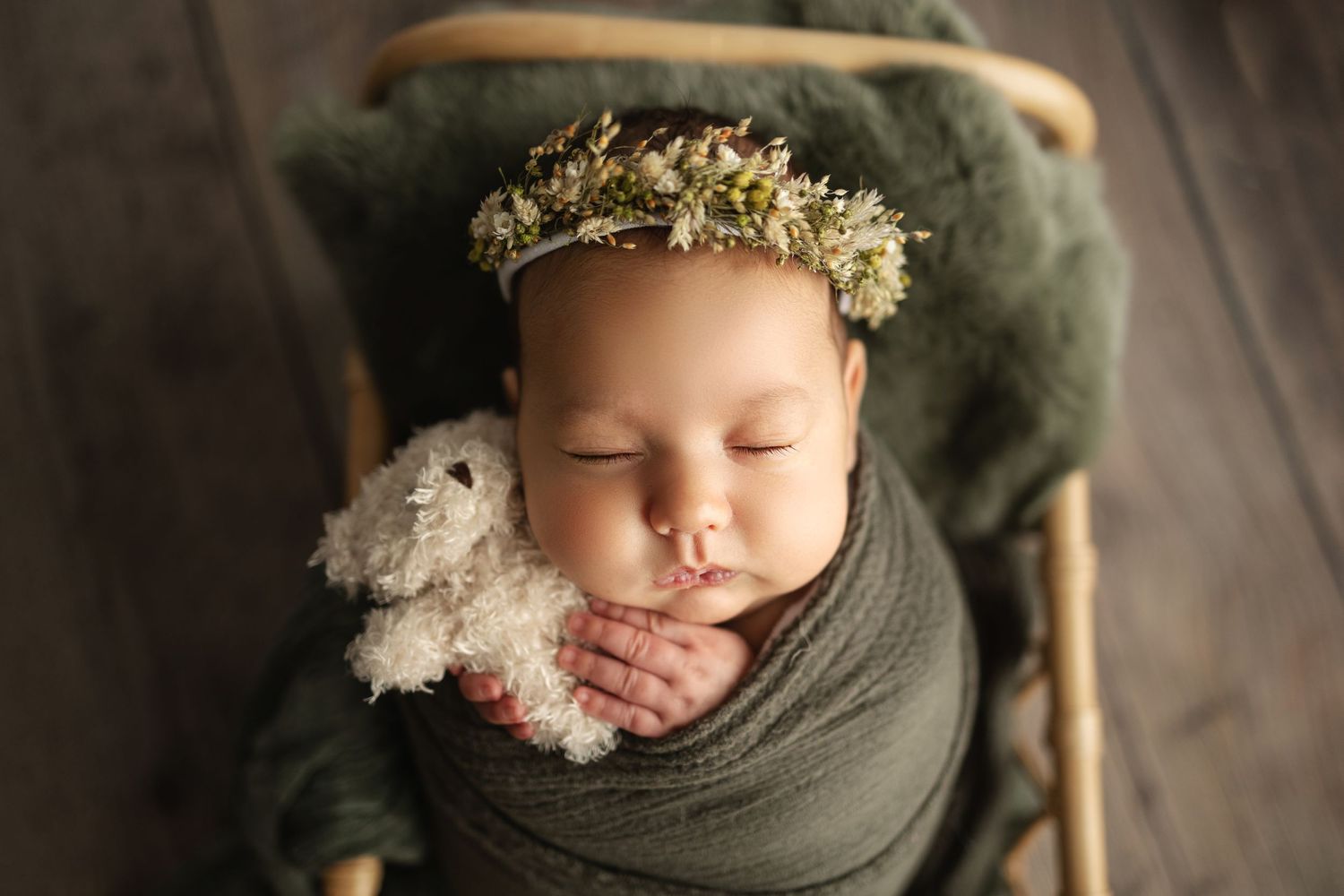 baby holding bear for newborn photos